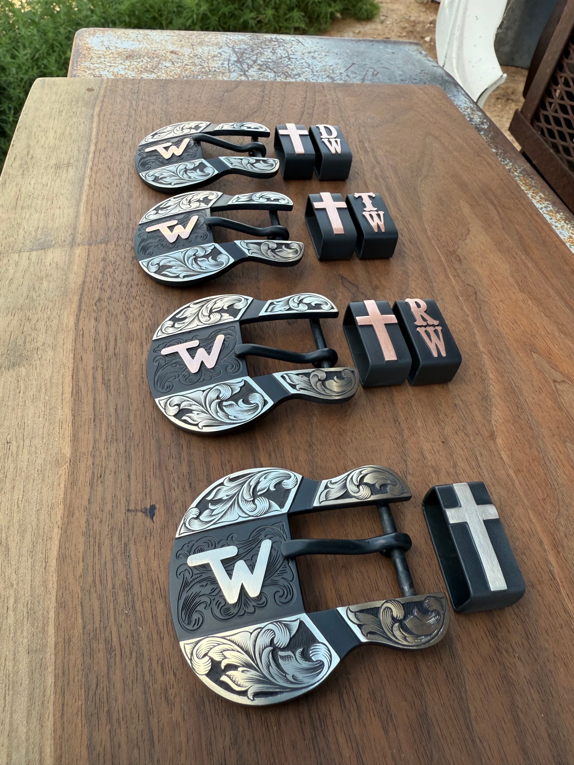 4 1 inch belt buckles on wood background 